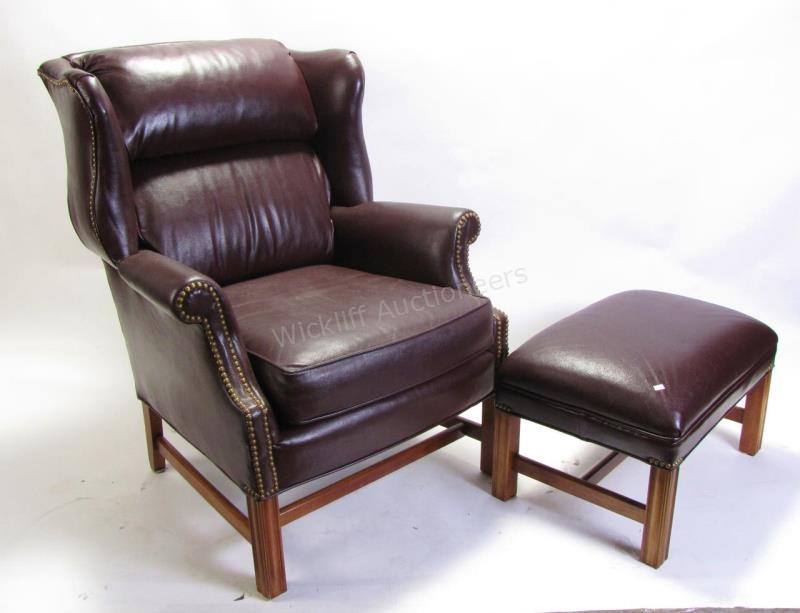 Appraisal: A Sam Moore fireside chair and ottoman wine-color pebbled leather