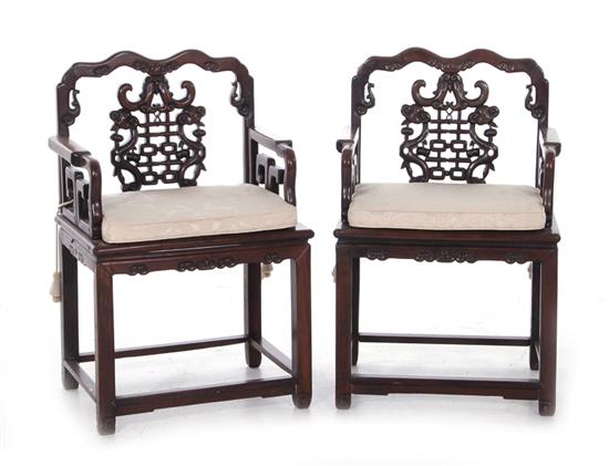 Appraisal: Pair Chinese carved hardwood armchairs Qing dynasty shaped crestrail pierced