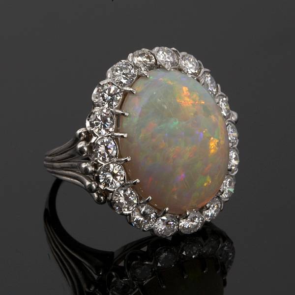 Appraisal: An opal and diamond ring centering an oval-shaped opal cabochon