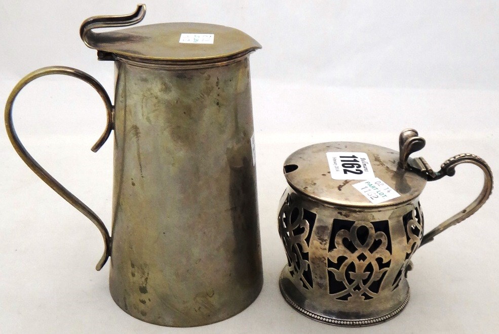 Appraisal: A silver mustard pot of bombe form with scroll pierced