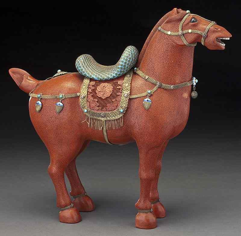 Appraisal: Chinese carved cinnabar horsewith a gilt silver saddle ''H x