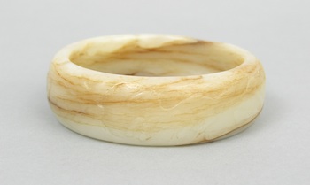 Appraisal: A Craved Jade Bangle Bracelet An archiastic carved jade bangle