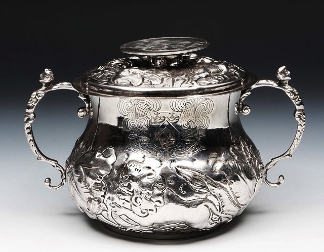 Appraisal: A CHARLES II SILVER LIDDED PORRINGER with embossed and chased