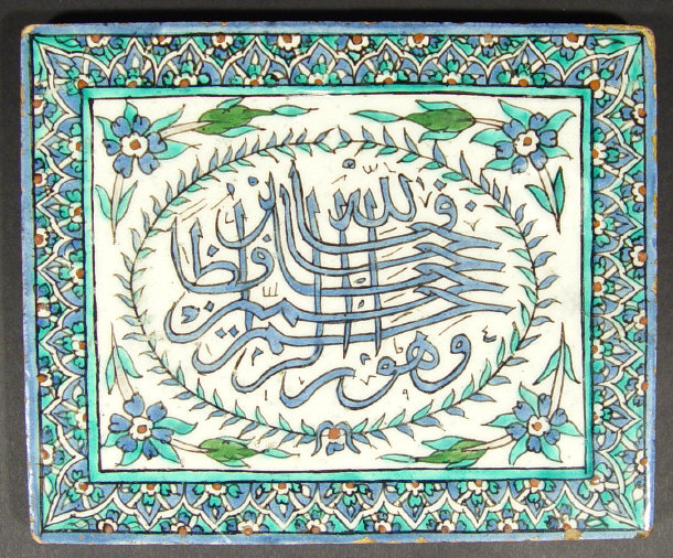 Appraisal: Persian tile hand painted with script in a blue floral