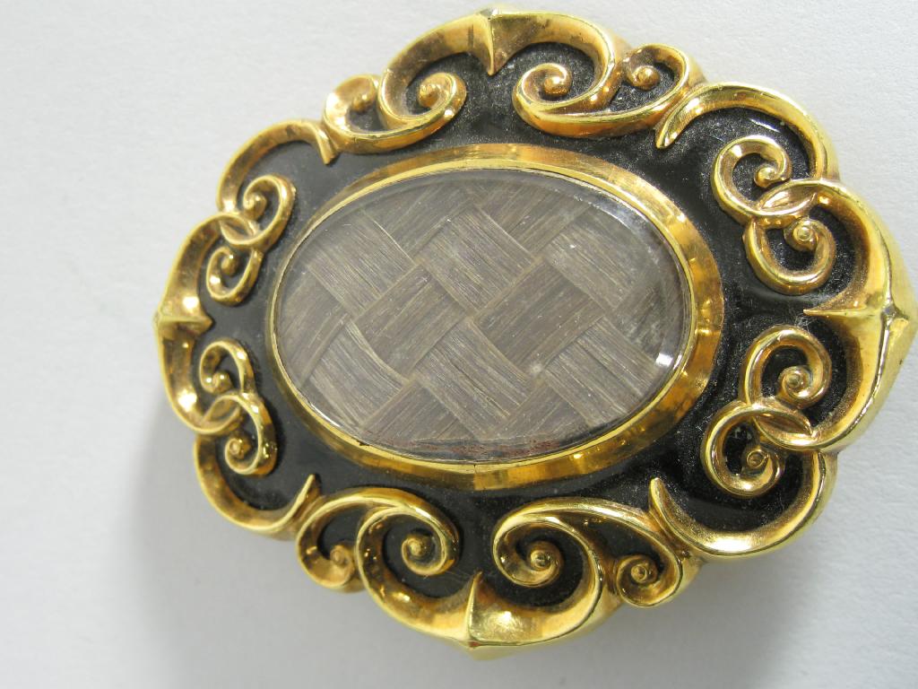 Appraisal: A Victorian Mourning Brooch the plaited lock of hair within