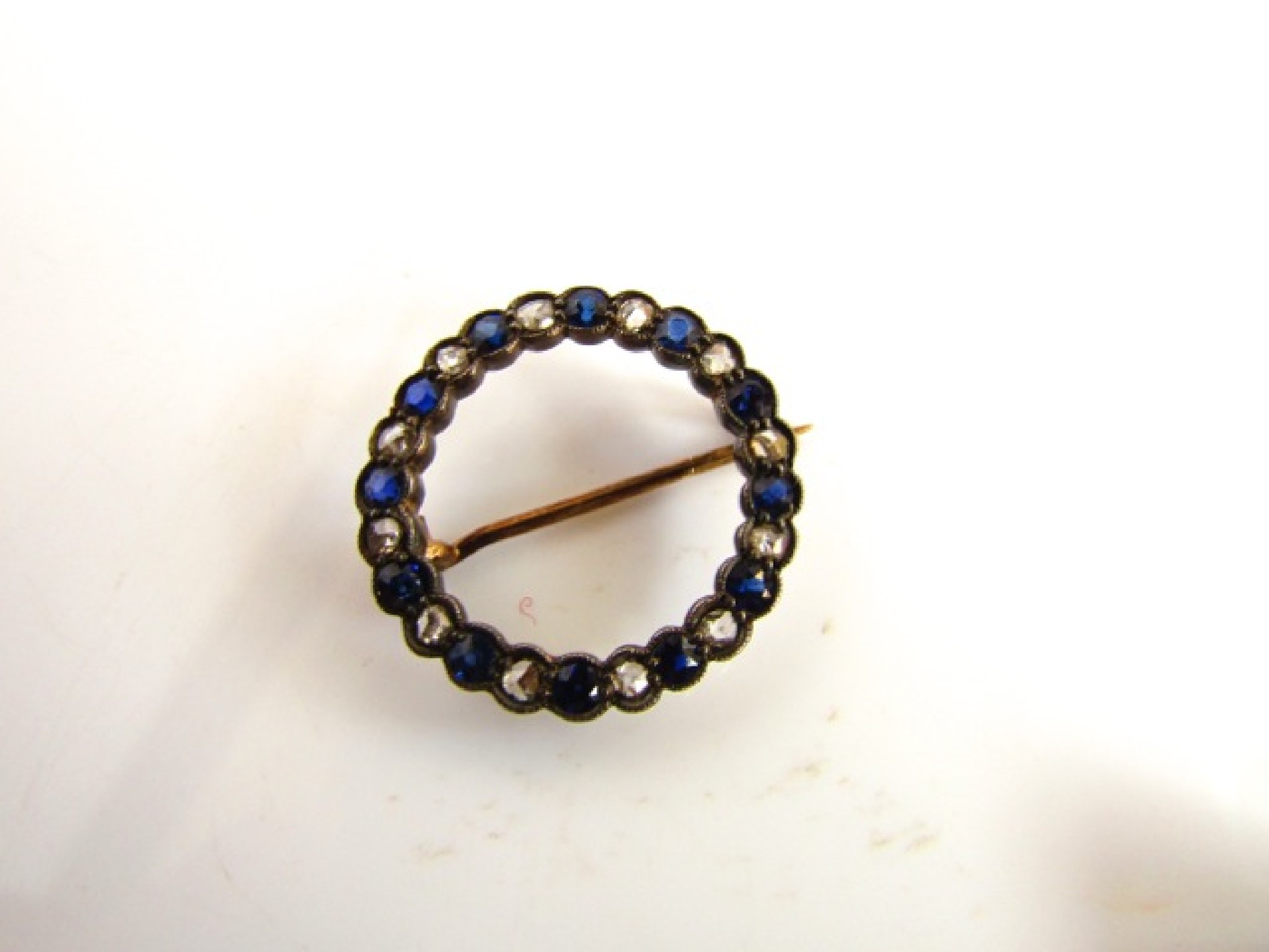 Appraisal: A Victorian style sapphire and diamond brooch of circular form