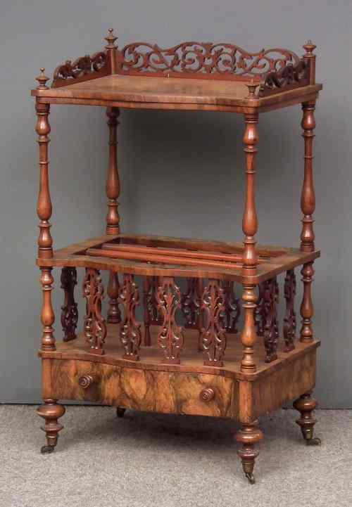 Appraisal: A Victorian walnut serpentine fronted Canterbury whatnot with pierced gallery