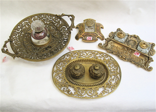 Appraisal: FOUR METAL DESK STANDS WITH INKWELLS a round pedestal bowl