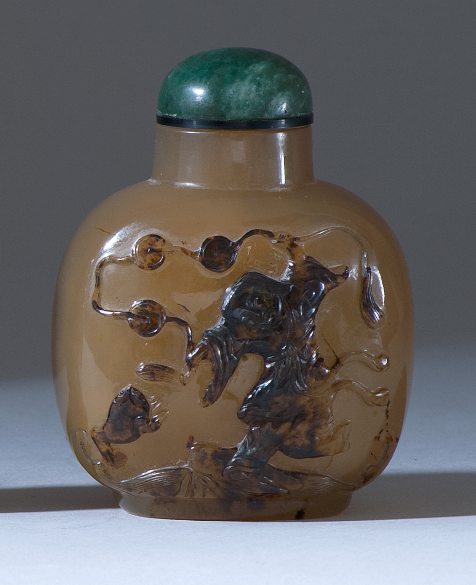 Appraisal: CHALCEDONY AGATE SNUFF BOTTLE th CenturyIn ovoid form with relief