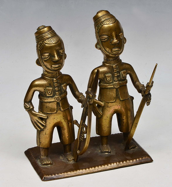 Appraisal: A NIGERIAN PROBABLY LAGOS COLONIAL CAST BRASS MODEL of two