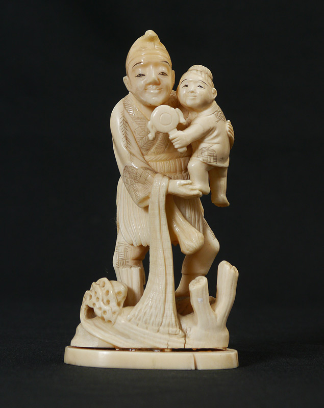 Appraisal: CARVED IVORY FISHERMAN CHILD Figural group with fisherman holding a