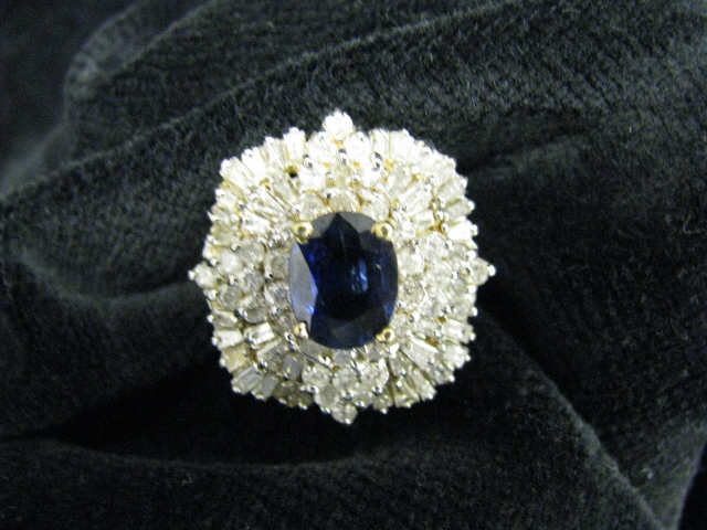 Appraisal: Sapphire Diamond Ring rich oval carat gem surrounded by diamonds