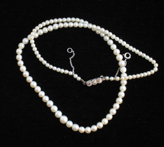 Appraisal: A GRADUATED ROW OF CULTURED PEARLS the white metal clasp