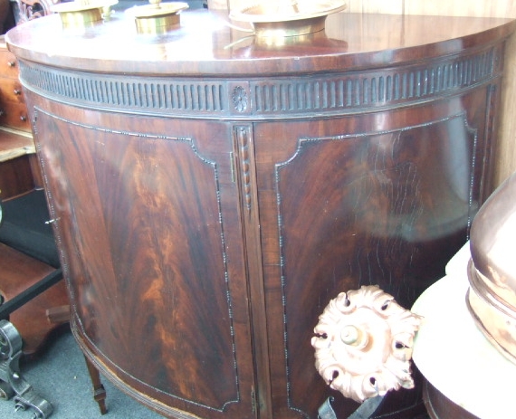 Appraisal: A late th century mahogany demi-lune side cabinet the fluted