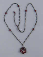 Appraisal: A silver and garnet necklace