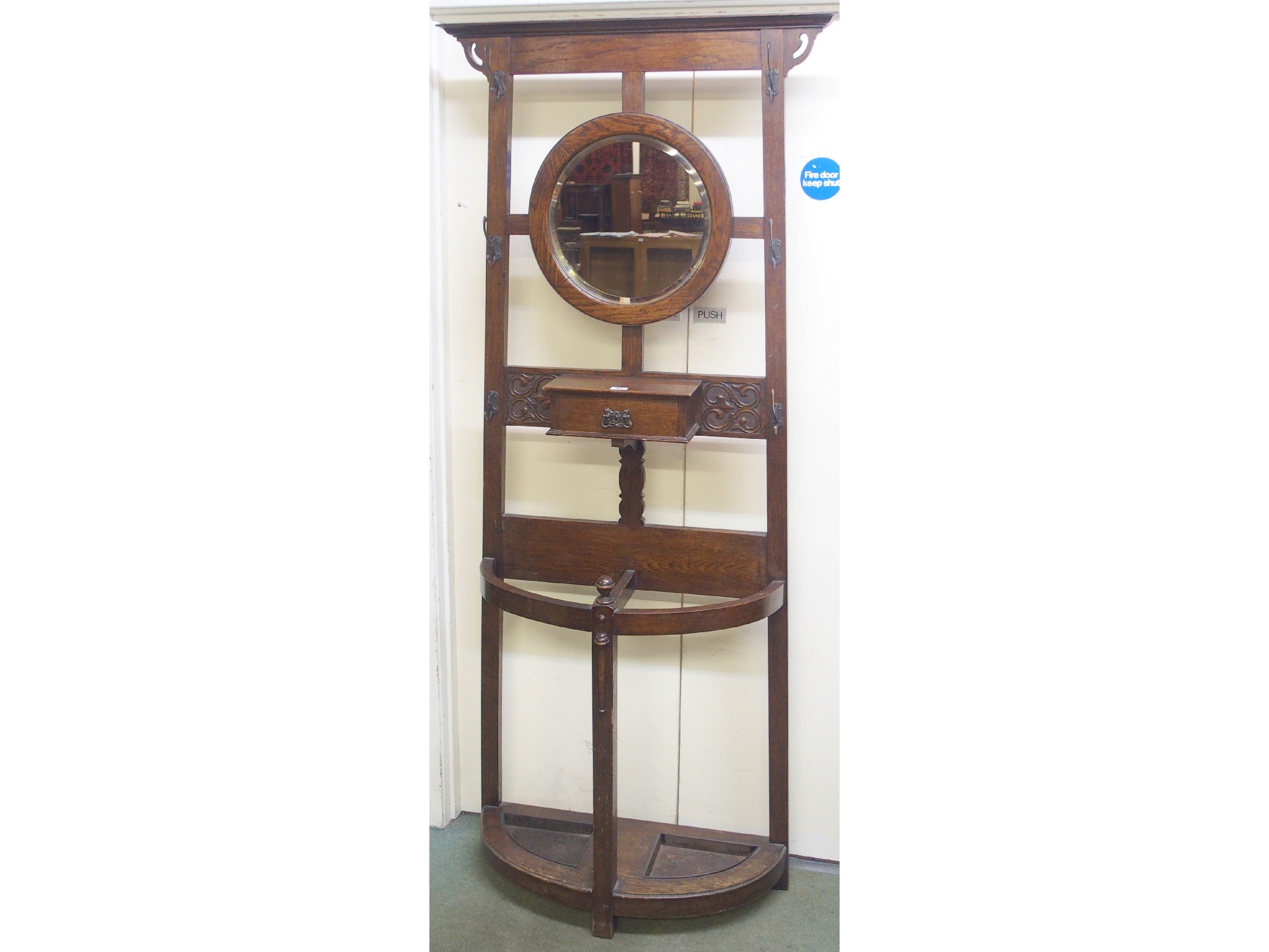 Appraisal: A Victorian oak hall stand with central round mirror