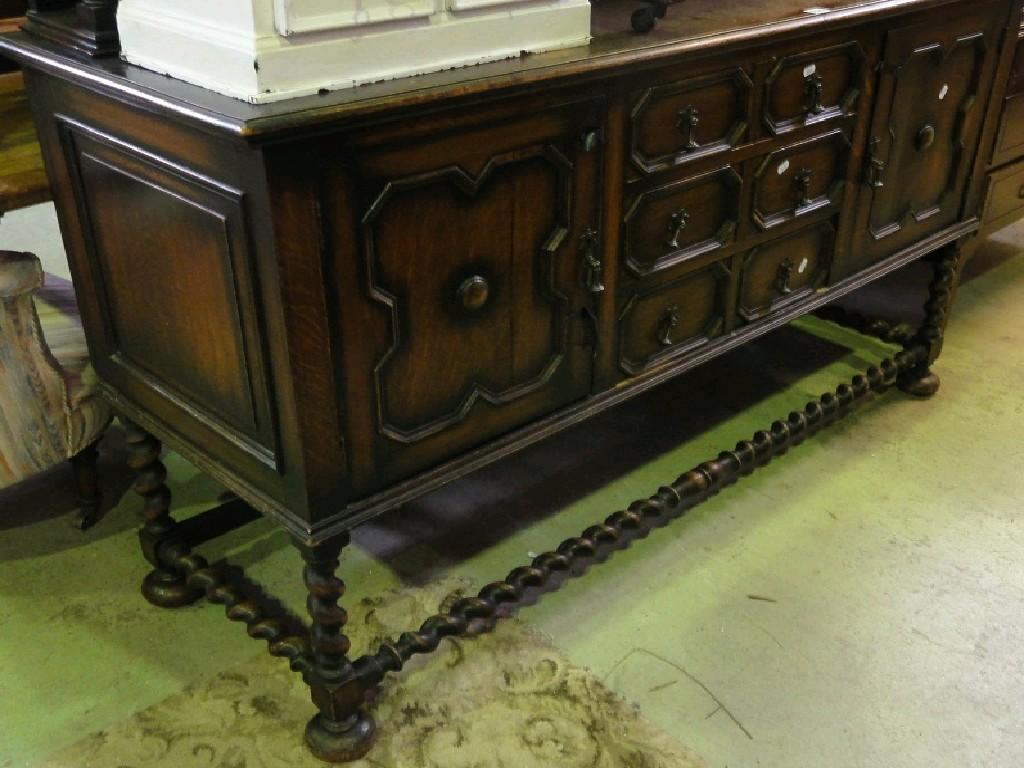 Appraisal: A 's Jacobean revival oak sideboard the raised panelled back