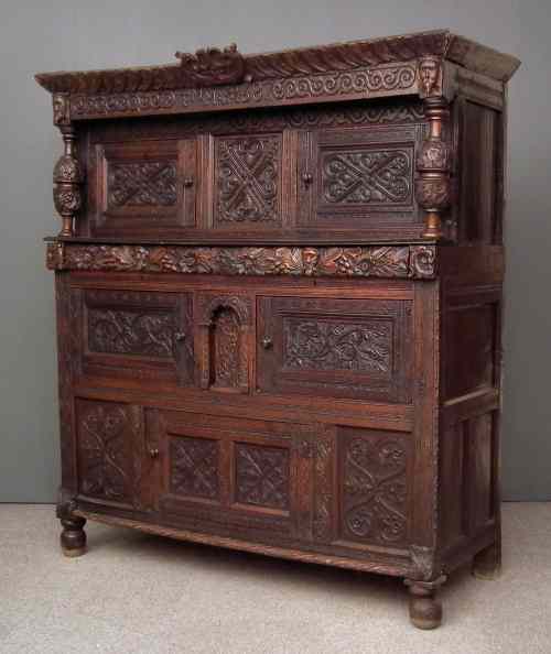 Appraisal: A th Century panelled oak court cupboard carved throughout with