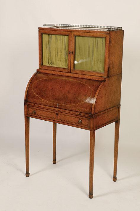 Appraisal: A REGENCY AMBOYNA CYLINDER WRITING DESK the raised top with