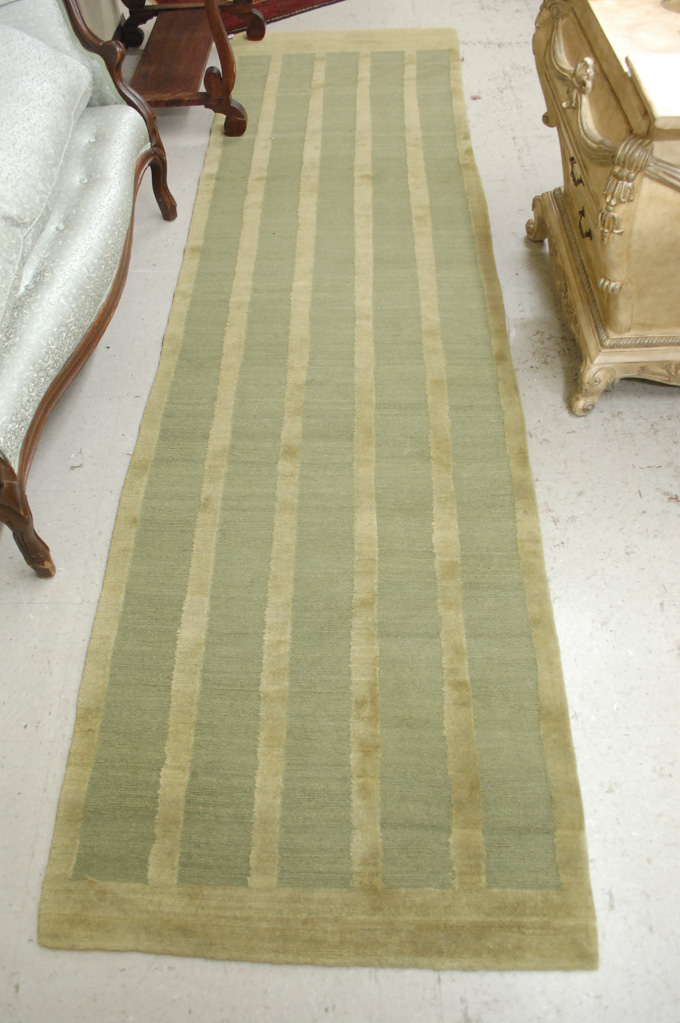 Appraisal: CONTEMPORARY TIBETAN RUNNER hand knotted in a plain green-on-green stripe