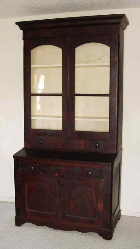 Appraisal: EARLY VICTORIAN STEP BACK BOOKCASE CUPBOARD Mahogany veneer glass door