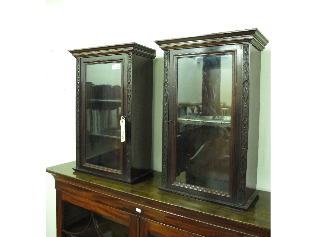 Appraisal: Pair of small carved mahogany glazed display cases