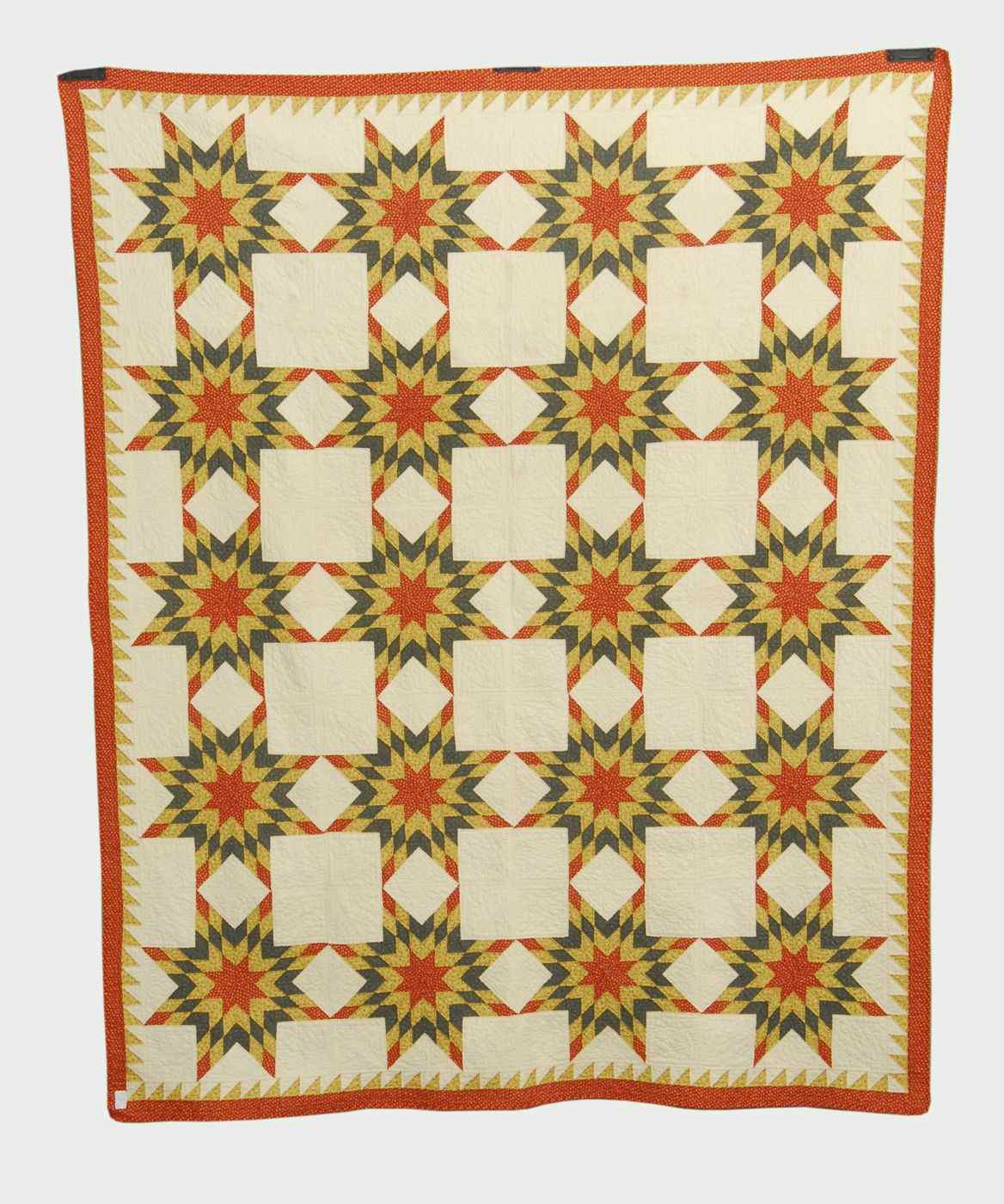 Appraisal: APPLIQU QUILTEarly th CenturyIn Starburst pattern Red green and yellow