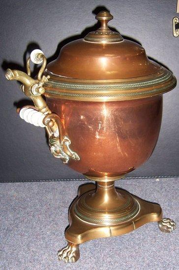 Appraisal: A copper two-handled urn and cover on a triangular base