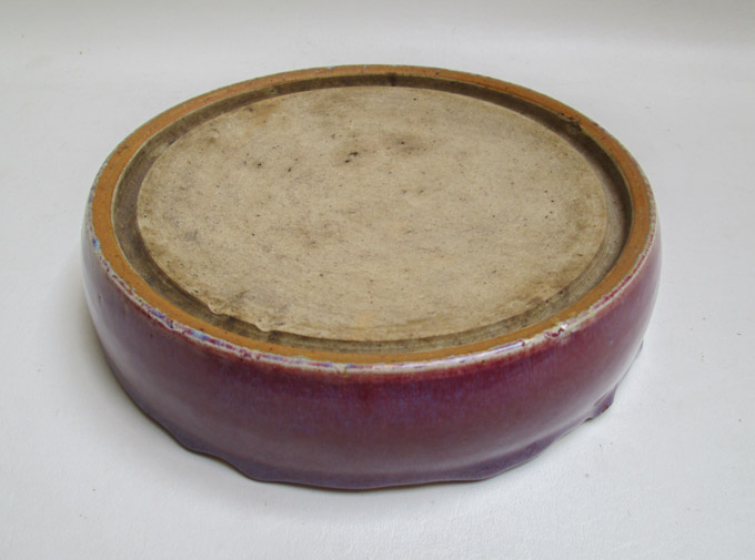 Appraisal: CHINESE PLUM GLAZE PORCELAIN INK DISH round with unglazed rim