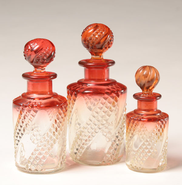 Appraisal: Three Baccarat amberina pressed glass bottles sawtooth swirl pattern on