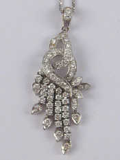 Appraisal: A white metal tests carat gold diamond pendant approx cm