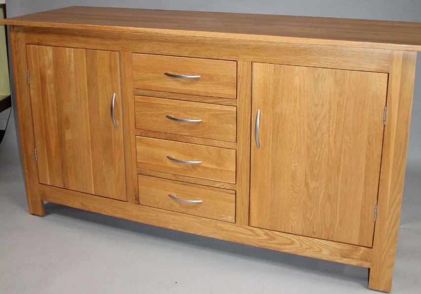 Appraisal: A modern light wood sideboard the plain rectangular overhanging top