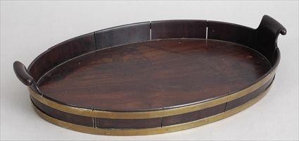 Appraisal: GEORGE III BRASS-BANDED MAHOGANY TRAY The oval gallery with bands