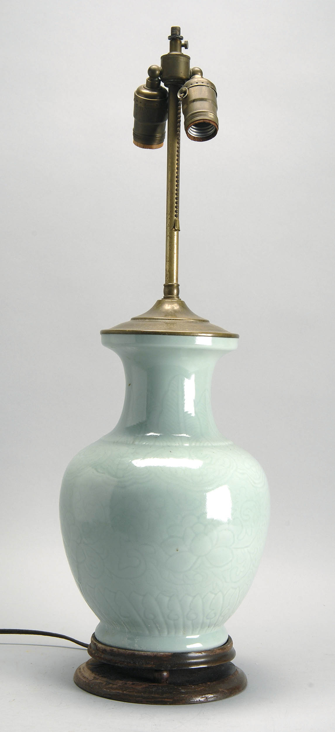 Appraisal: CARVED CELADON PORCELAIN VASE Circa In baluster form with peony