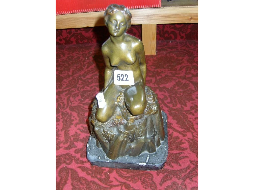 Appraisal: An Austrian cast metal figure of a seated nude woman