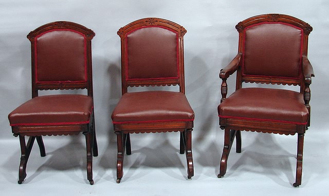 Appraisal: Carved arched crest rail brown leather covered back and over-upholstered