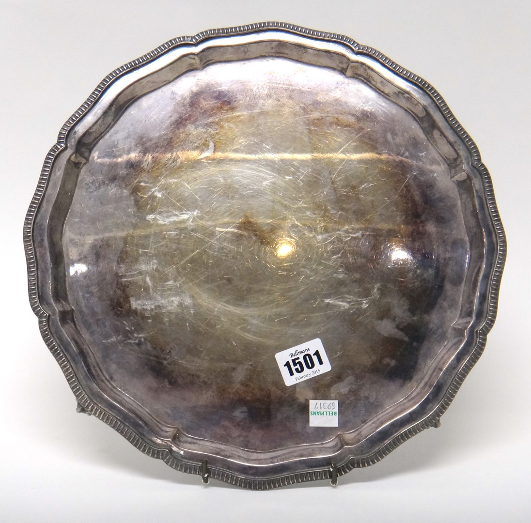 Appraisal: A silver shaped circular salver decorated with a beaded rim