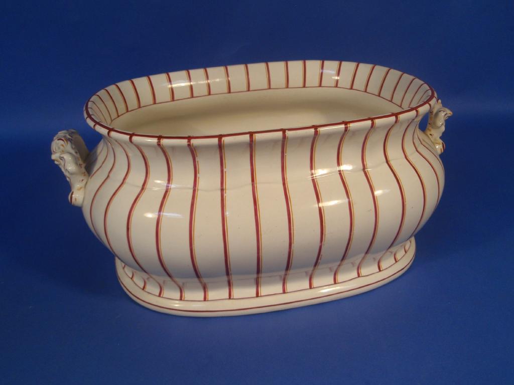 Appraisal: A Victorian pottery foot bath decorated with red and orange