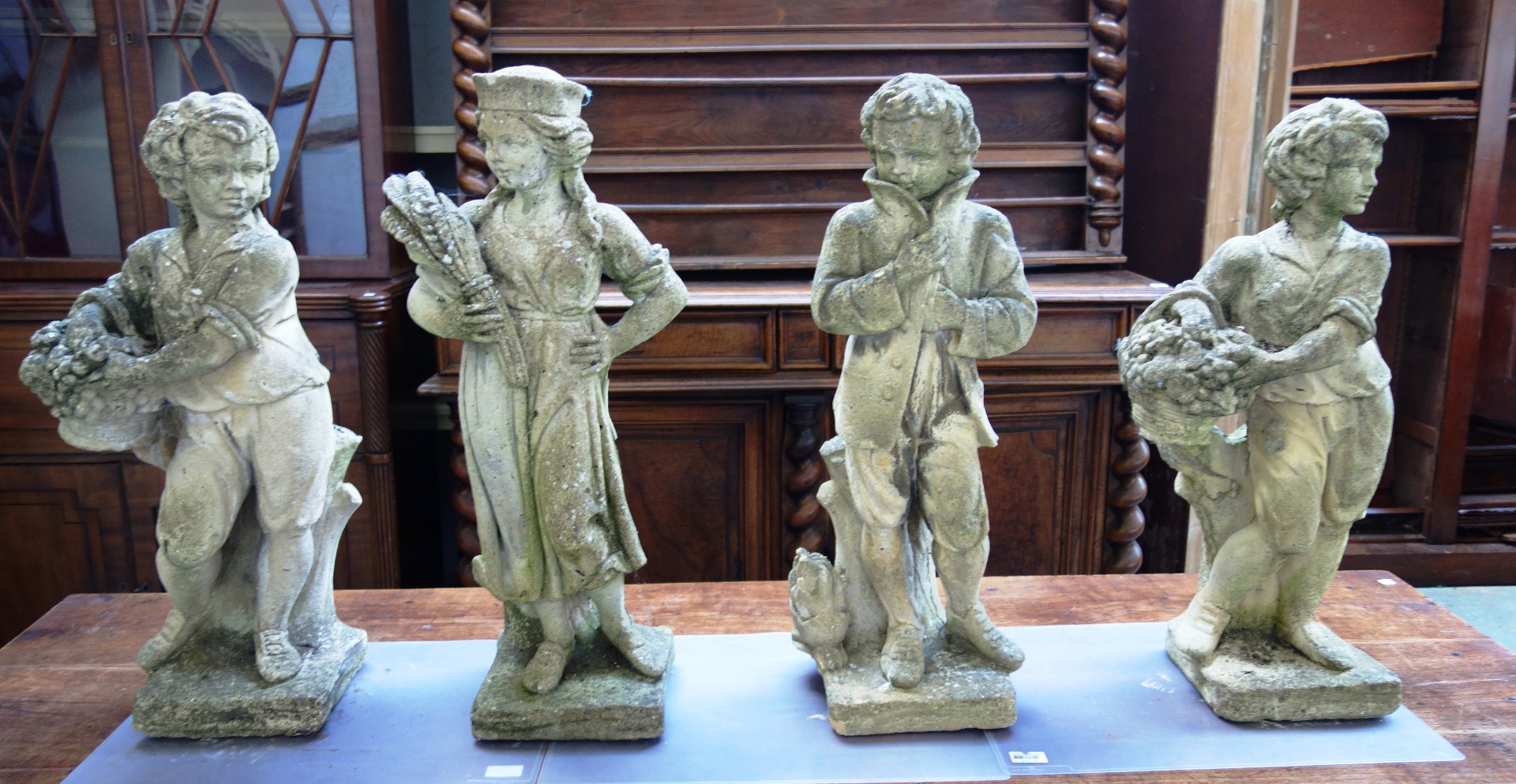 Appraisal: A set of four reconstituted stone figures depicting three of