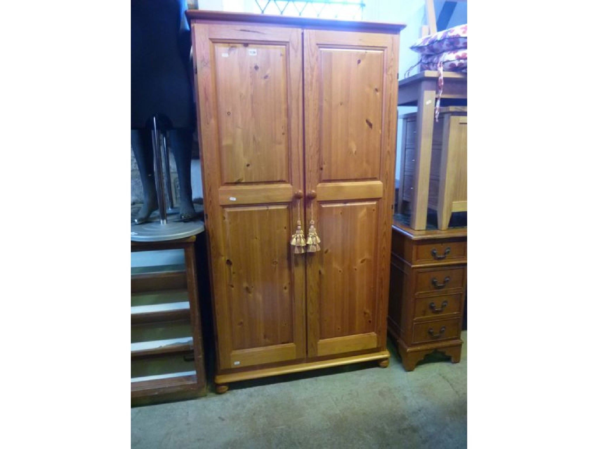 Appraisal: A small modern stripped pine wardrobe enclosed by a pair