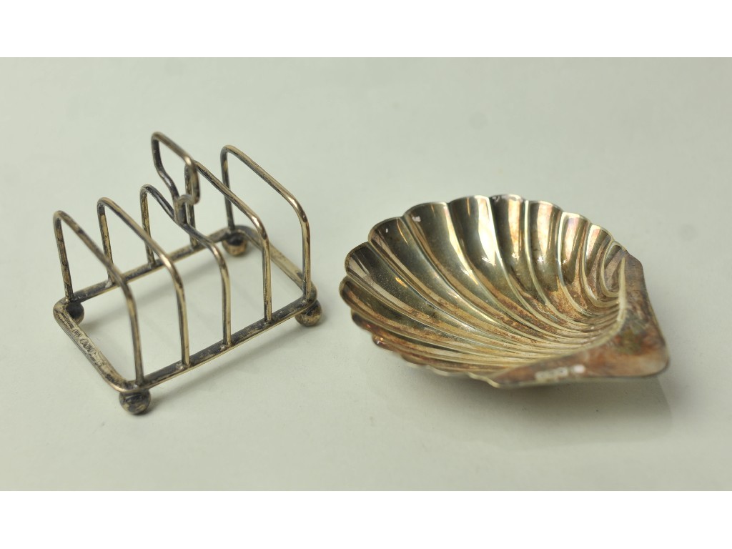 Appraisal: Lot comprising silver toast rack and silver shell shaped dish