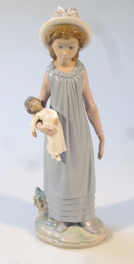 Appraisal: A Lladro figure of a girl holding doll wearing flowing