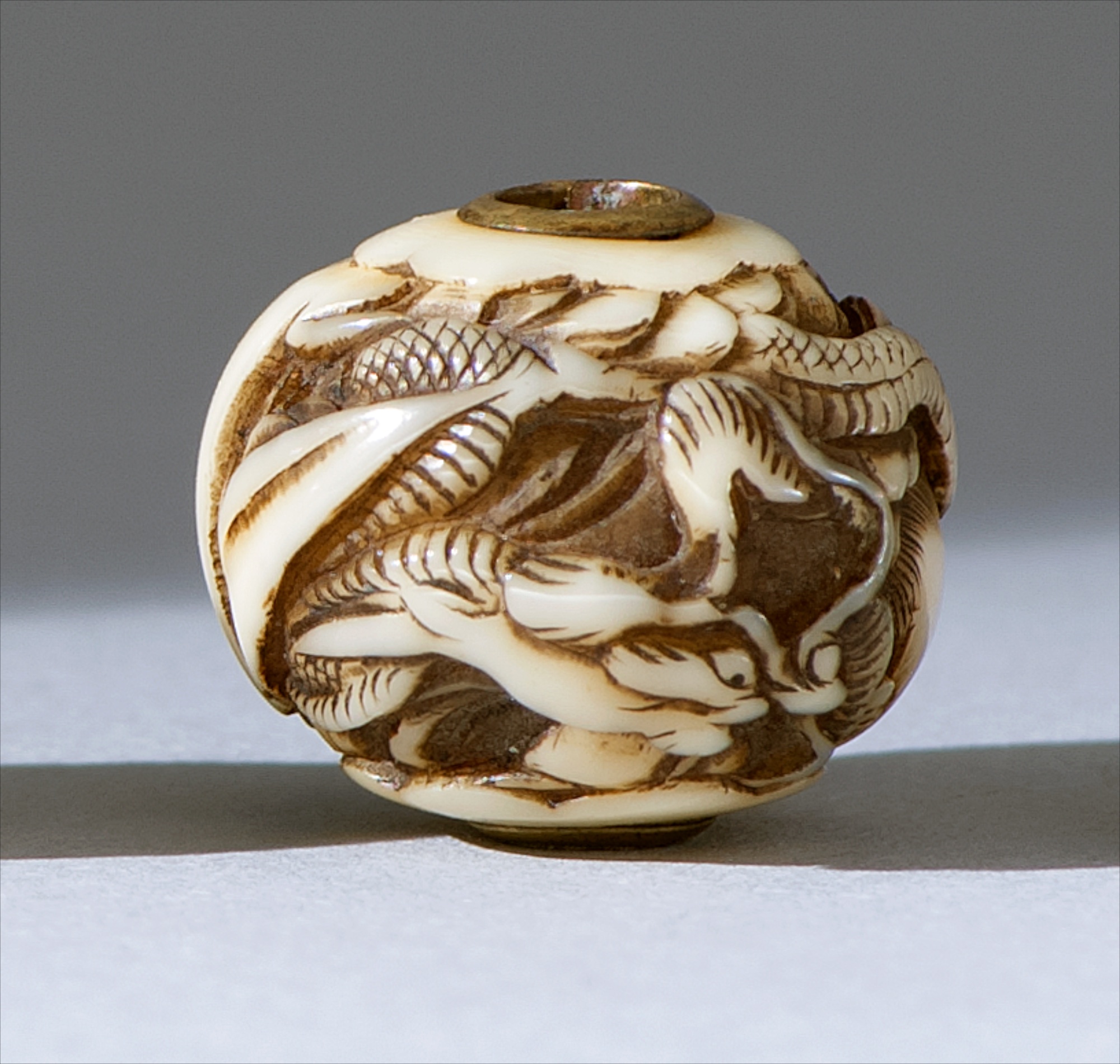 Appraisal: IVORY OJIME th CenturyIn ball form with relief dragon design