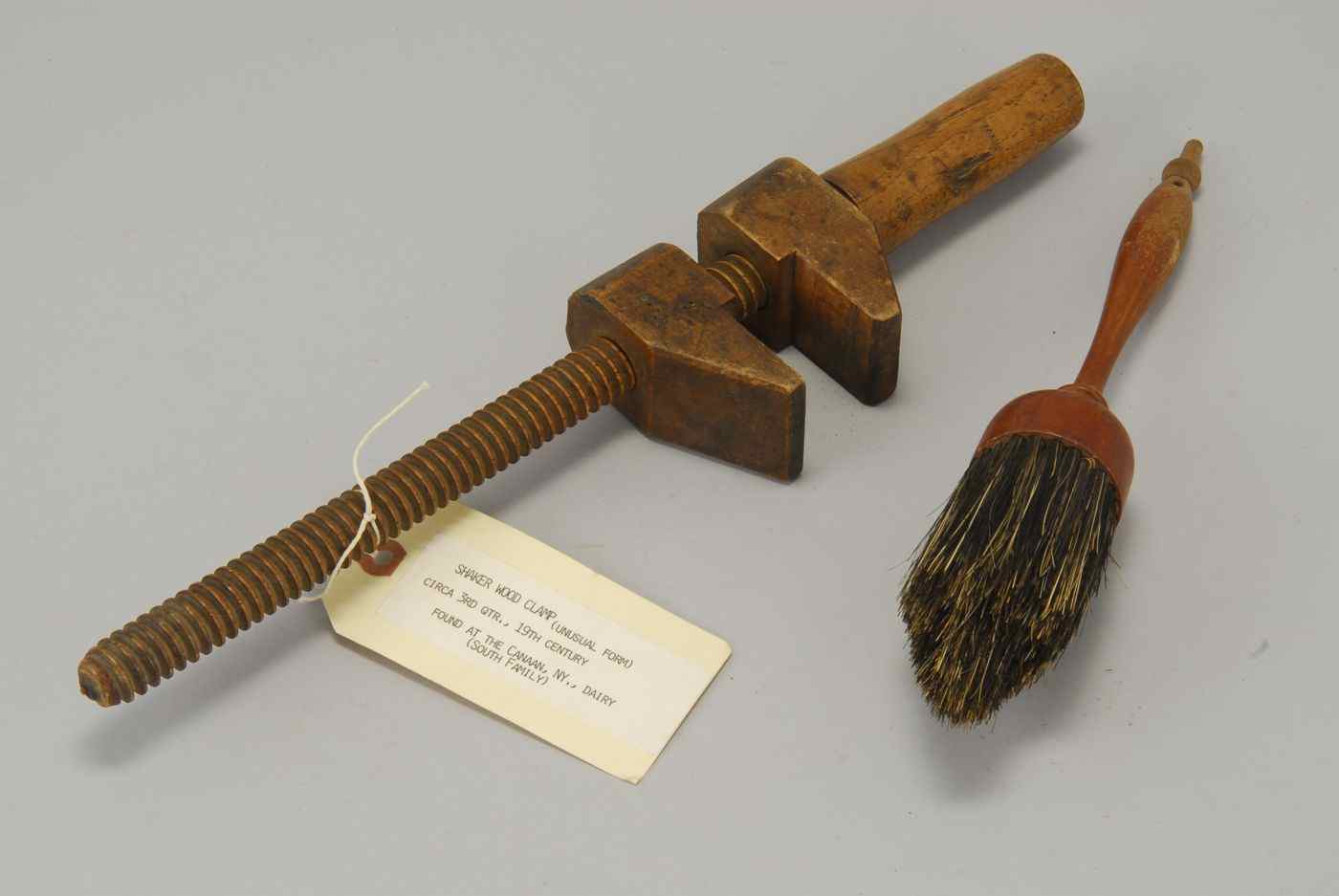 Appraisal: TWO SHAKER WOODEN ITEMSLate th CenturyHandled brush length and a