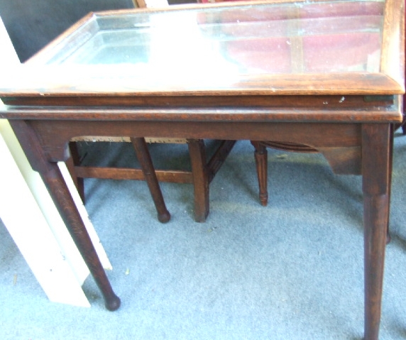 Appraisal: An oak bijouterie table with bevelled glass top and mirror