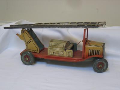 Appraisal: A tinplate fire engine with extension ladder and metal wheels