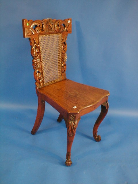 Appraisal: A Victorian carved oak hall chair with caned back and