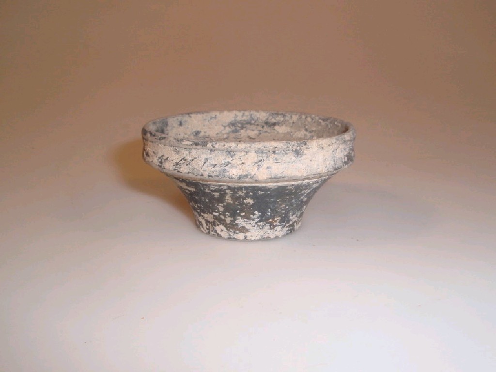 Appraisal: A small Roman black pottery bowl with a vertical mouth