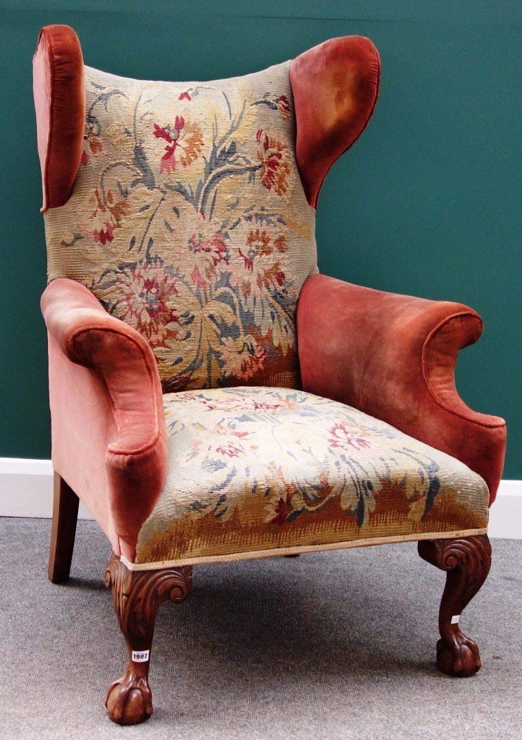 Appraisal: An th century style shaped wingback easy armchair on mahogany