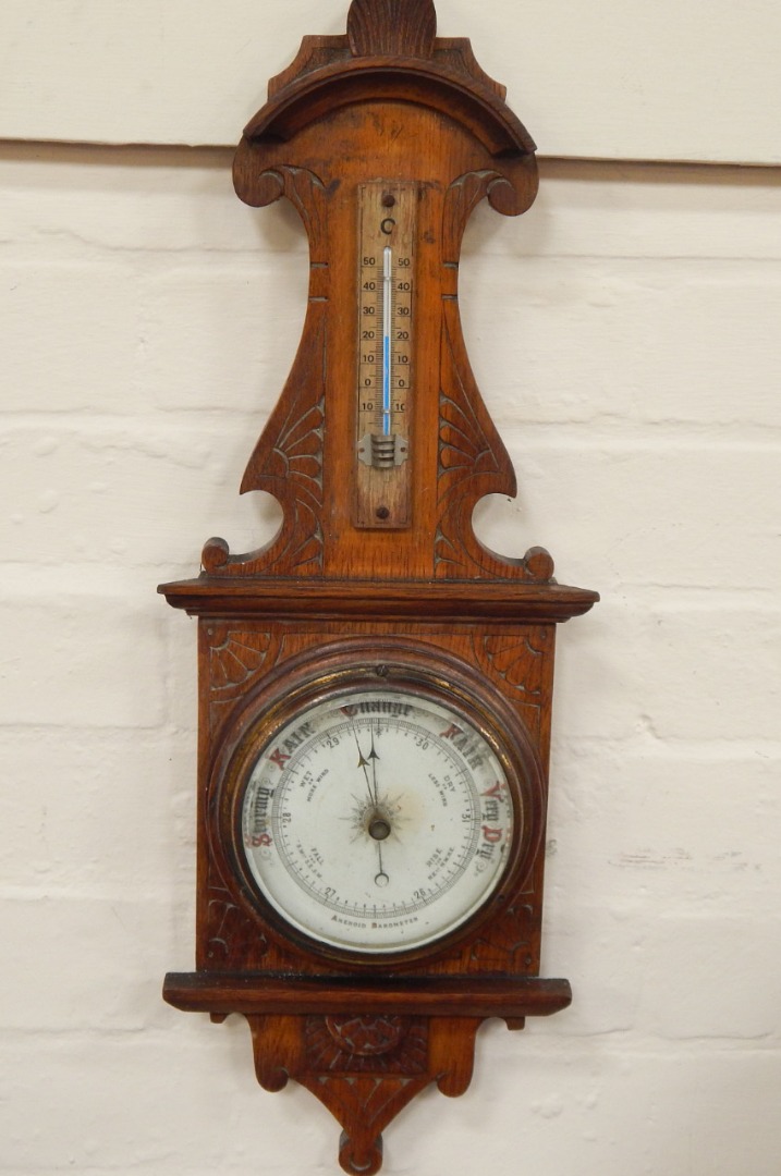 Appraisal: A 's oak aneroid barometer having cream dial with brass